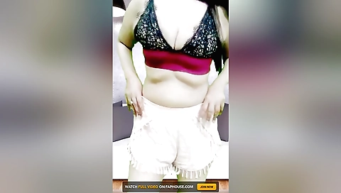 Indian brunette with big breasts masturbates on bed