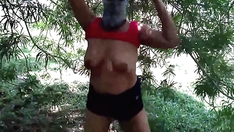 Brunette girl with huge tits blows a guy in the rain