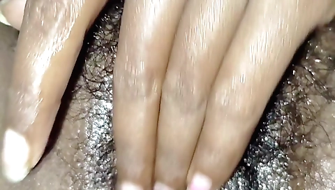 Indian girl with a sexy look is showing her hairy pussy